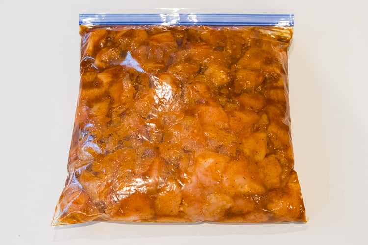 The cup-up chicken is soaking in the chipotle pepper marinade.