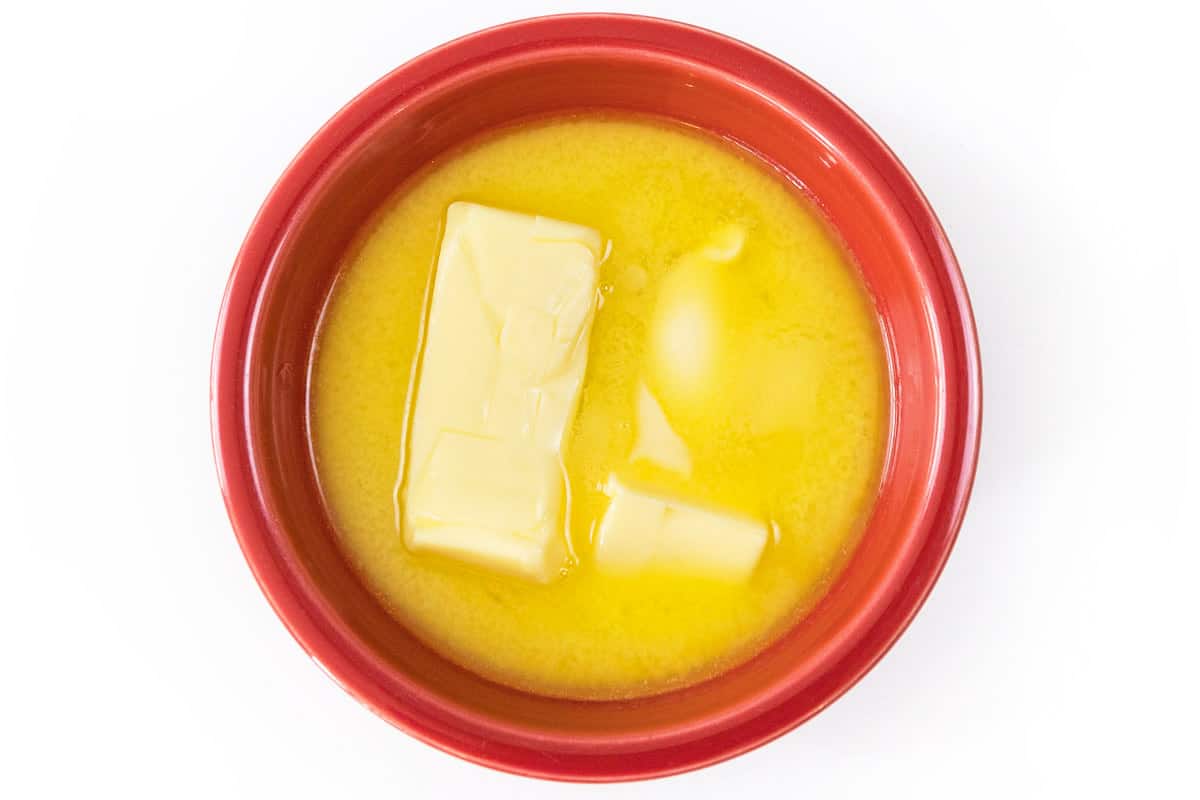 Two sticks of softened butter in a bowl.