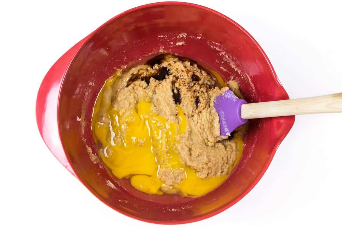 The softened butter, sugar, and light brown sugar are blended well.