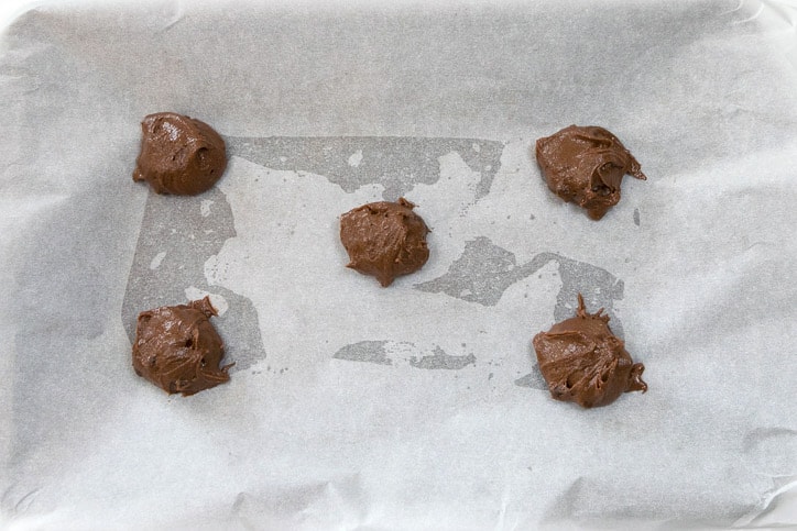 Sea Salt Chocolate Chip Cookie dough on parchment paper on a cookie sheet.