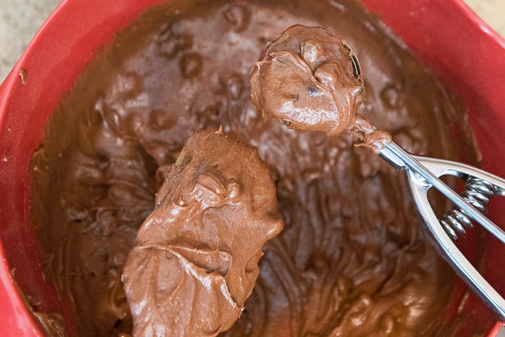 A cookie scoop filled with cookie dough.