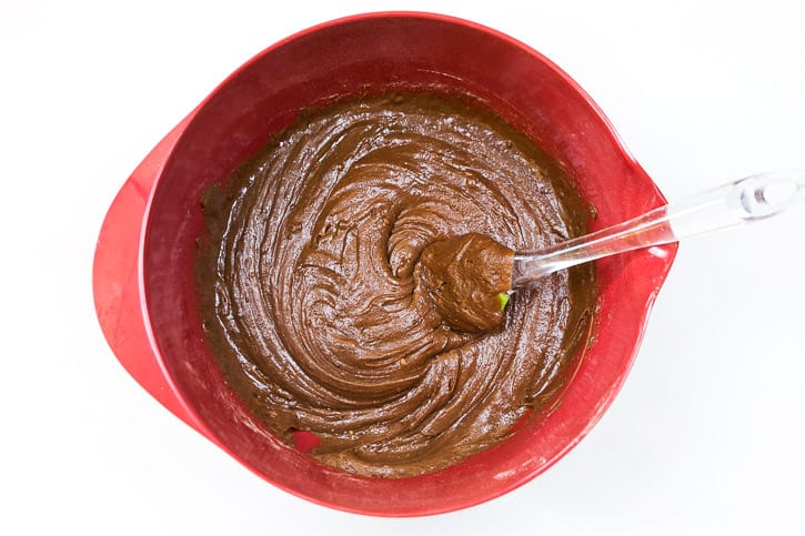 Dry and wet ingredients are blended into a chocolate cookie dough.