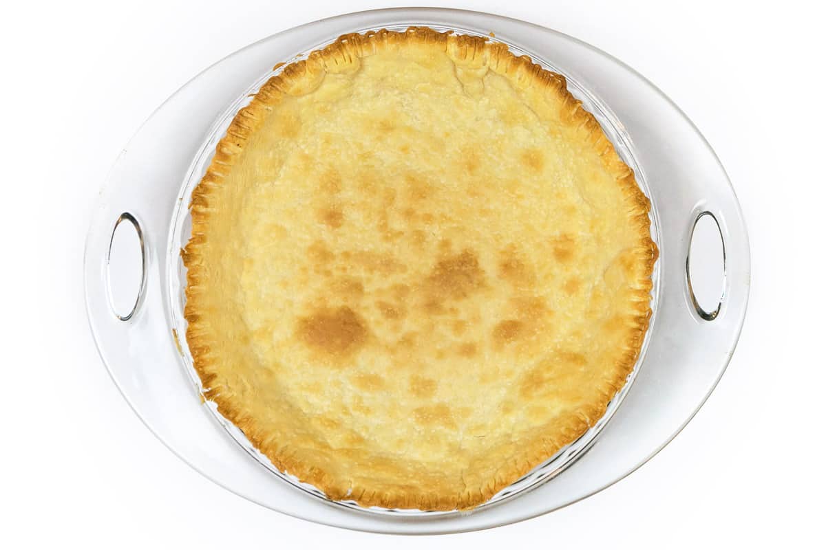 A baked bottom pie crust in a pie pan.