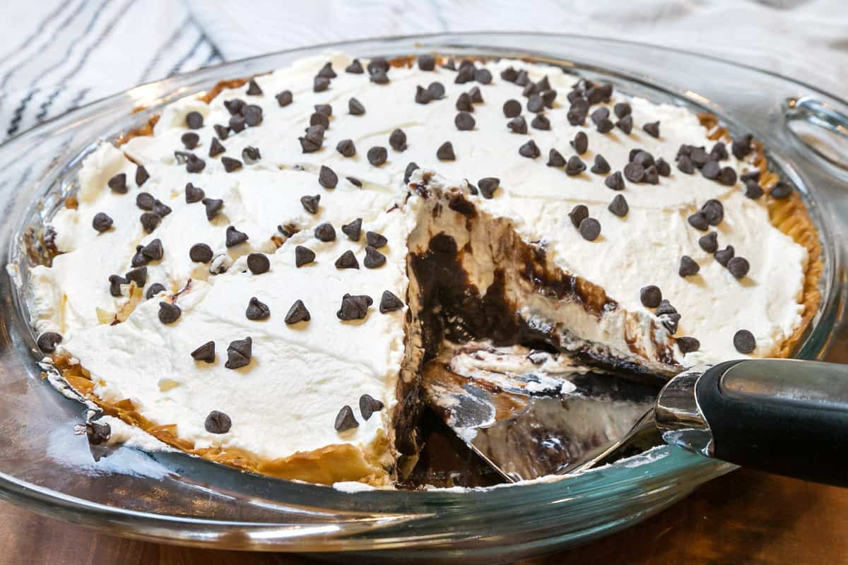A slice of chocolate pie was removed from the pie dish.