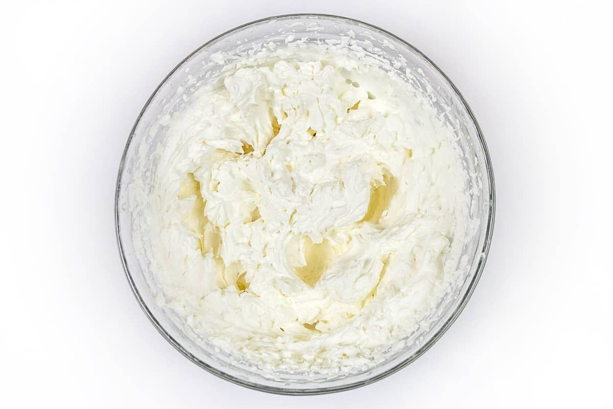 Whipped cream in a mixing bowl.