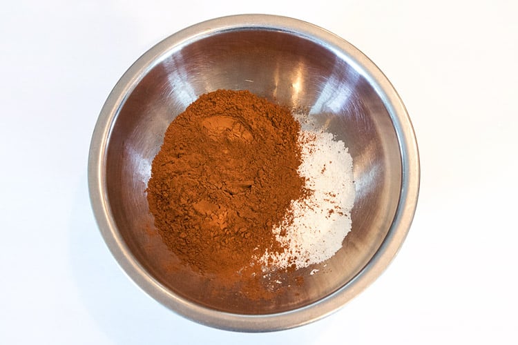 Two-thirds cup of unsweeteded cocoa and two tablespoons of cornstarch in a bowl.