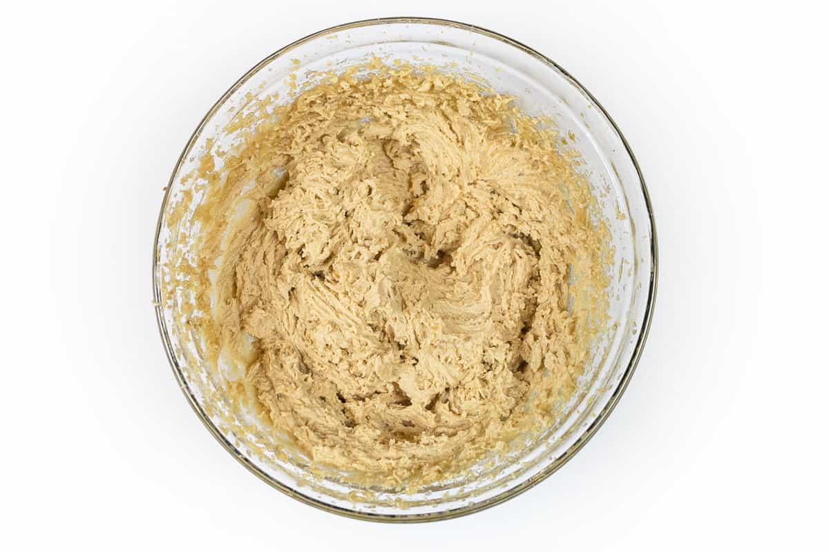 The eggs, vanilla extract, and butter-sugar mixture are mixed in a bowl.