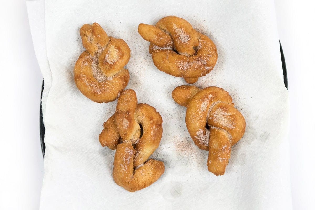 The donuts are sprinkled with cinnamon and sugar.