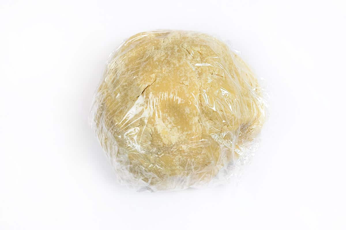 The dough is wrapped in plastic wrap and put into the refrigerator for thirty minutes.