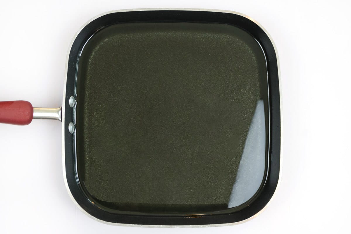 Vegetable oil in a deep dish frying pan.