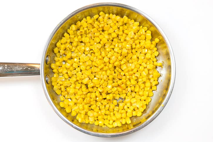 Roast the corn in the frying pan on medium-high heat, then reduce heat to medium for a total of about ten to fifteen minutes. Then set aside to cool.
