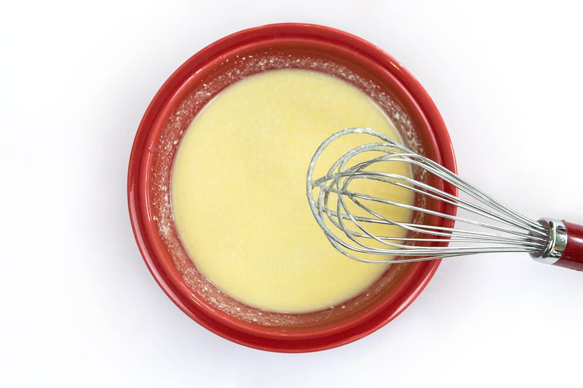 Milk and vanilla extract are added to the butter mixture.