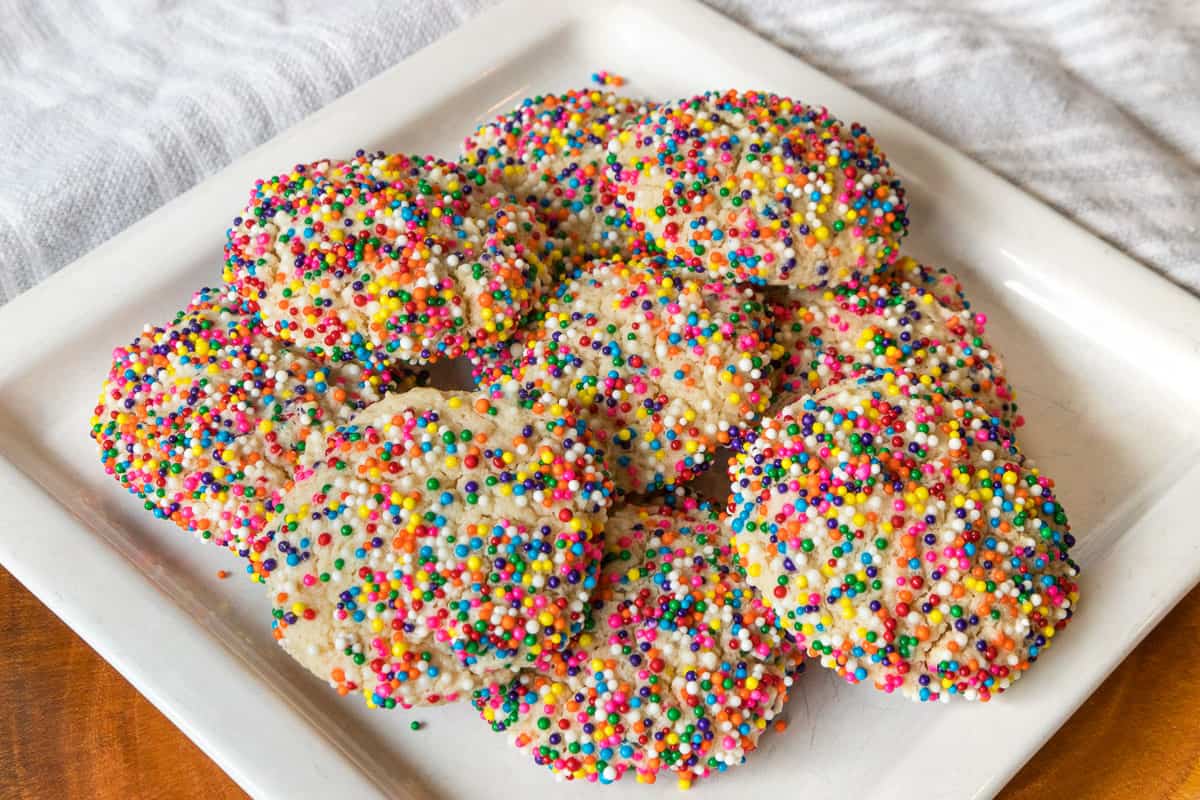 Cream cheese sprinkle cookies on a plate.