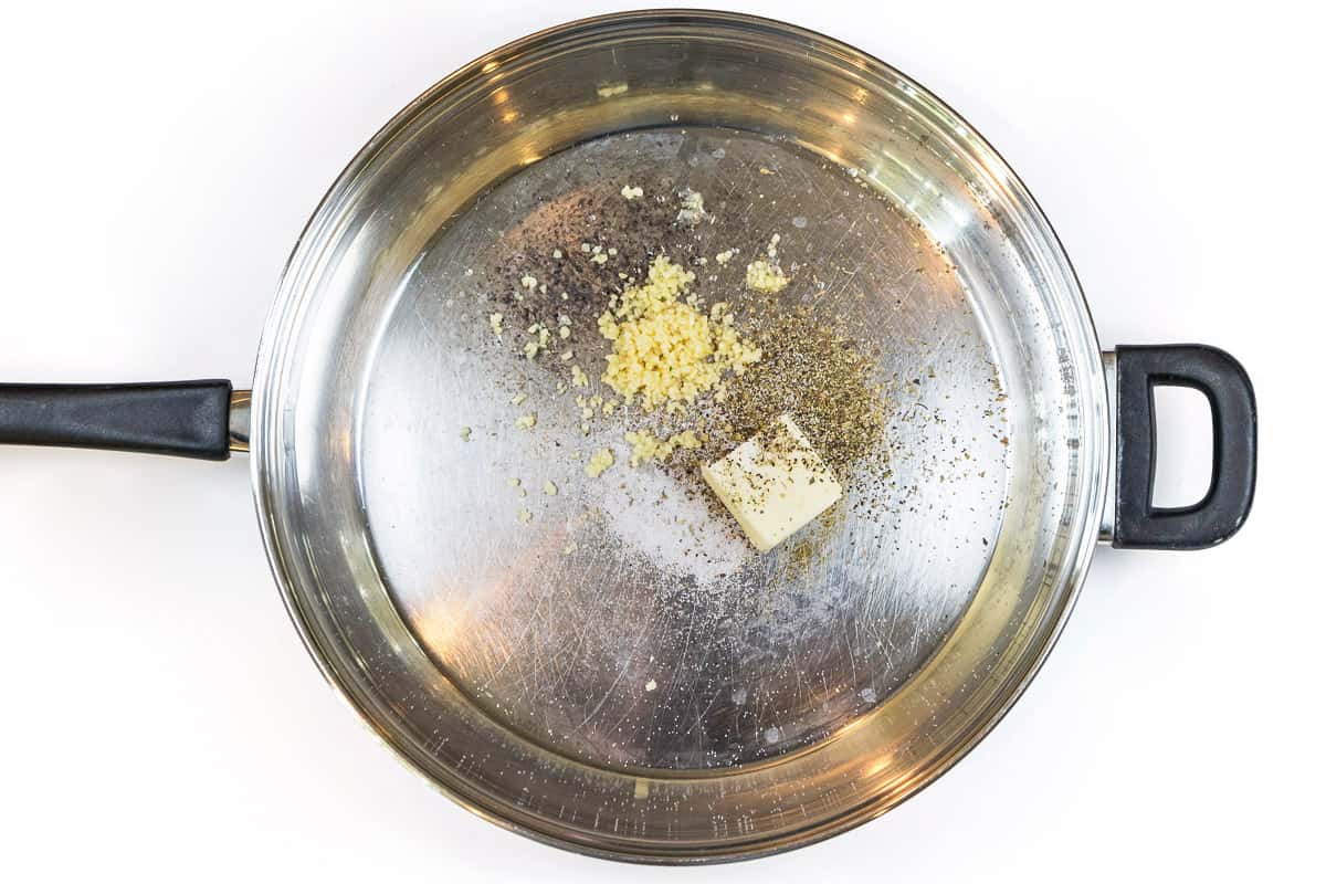 Butter, minced garlic, Italian seasoning, salt, and pepper in a frying pan.