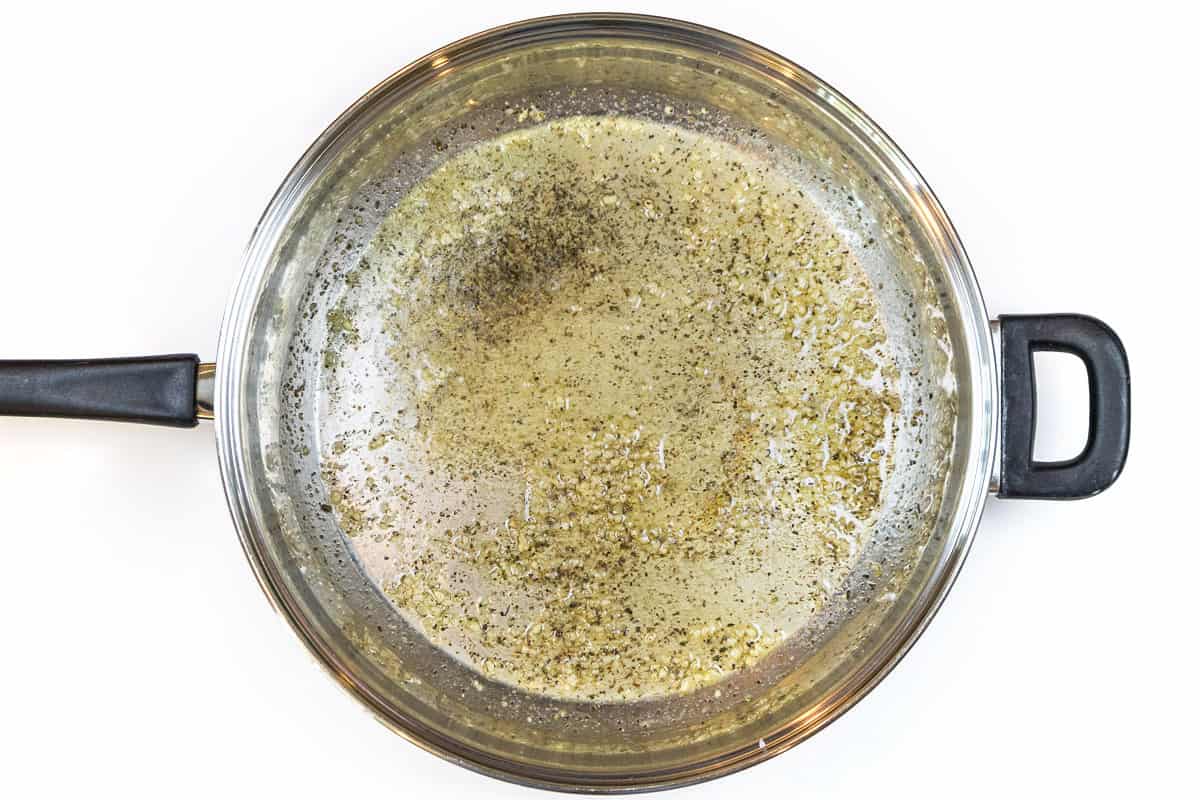 Butter, minced garlic, Italian seasoning, salt, and pepper in a frying pan.