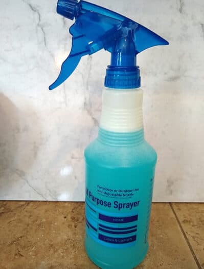 Homemade shower cleaner with dish soap and vinegar in a spray bottle.