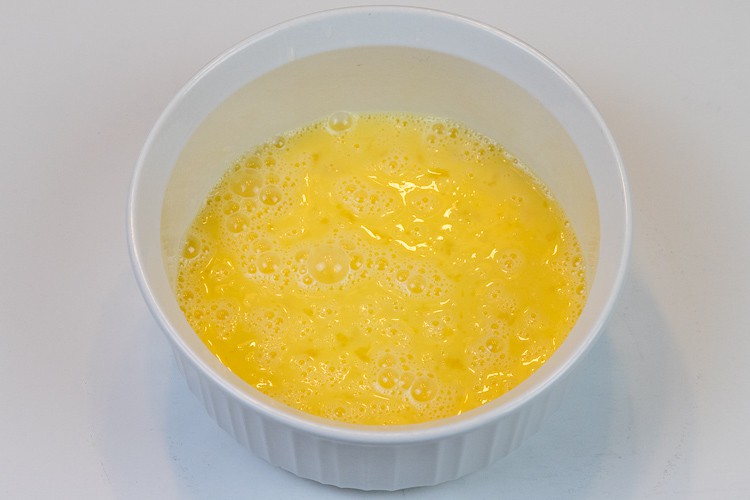 Beat three eggs in a bowl.