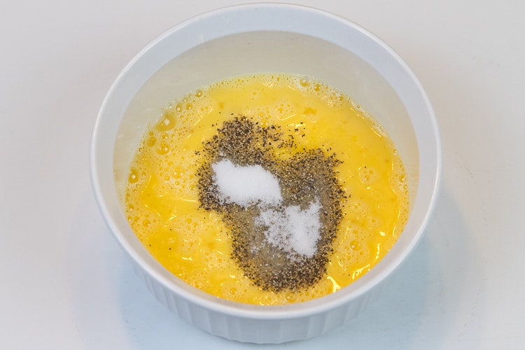 Add the salt and pepper to the eggs.