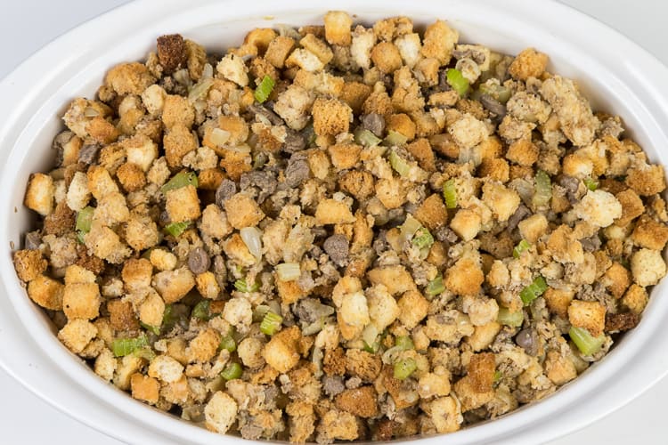 Put Thanksgiving dressing in the oven at three hundred and twenty five degrees for forty-five minutes, then take out, stir, and put back into the oven uncovered for fifteen more minutes.
