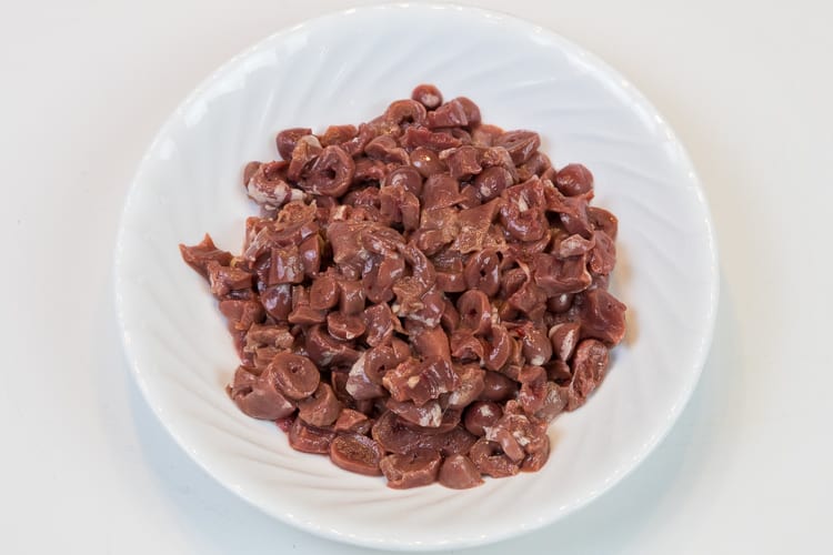 Chicken hearts cut up.