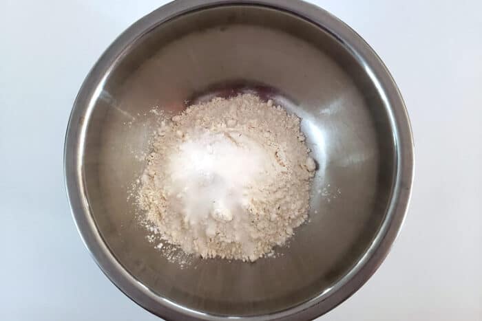 Flour, baking powder, salt, and sugar in a bowl for fried dumplings..