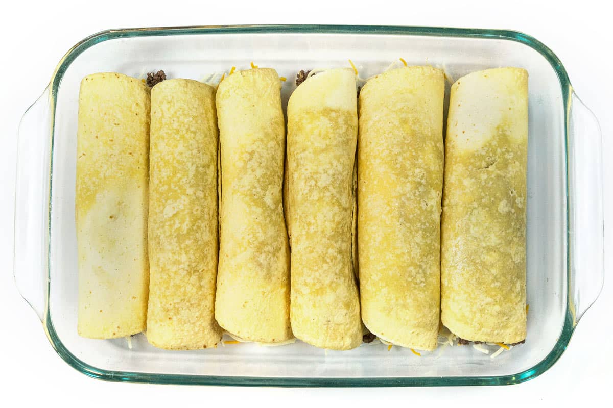 Spray a baking dish. Place six folded tortillas in the baking dish. Place the other four folded tortillas in an eight by eight baking pan.