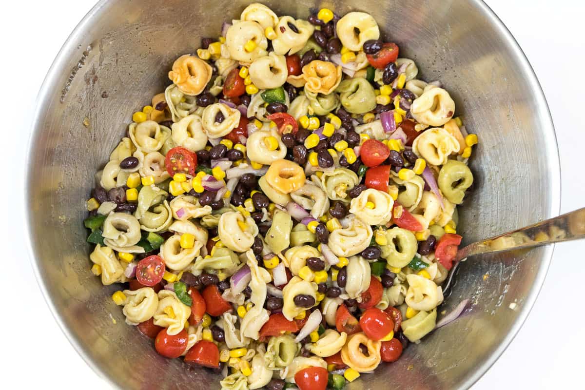 The roasted corn salsa is added to the tortellini, black beans, and olive oil.