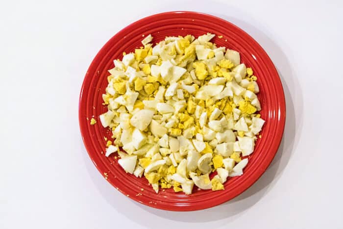 Eight cut-up hard-boiled eggs on a plate.