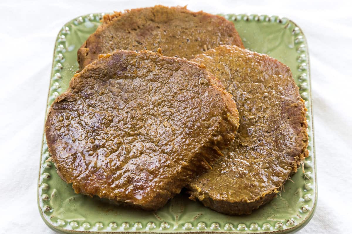 Eye of round steak on a plate ready to eat.