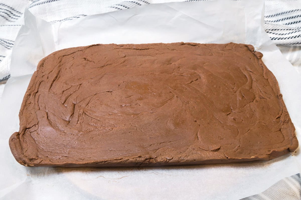 The fantasy fudge has cooled and is removed from the baking dish.