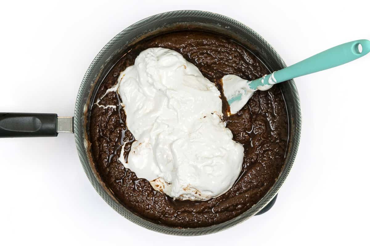 The marshmallow creme is added to the fudge mixture.