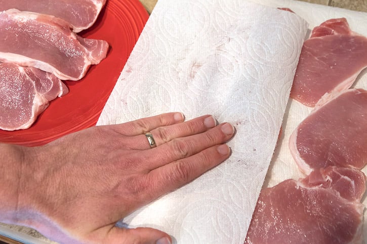 Use a paper towel to pat dry each pork chop.