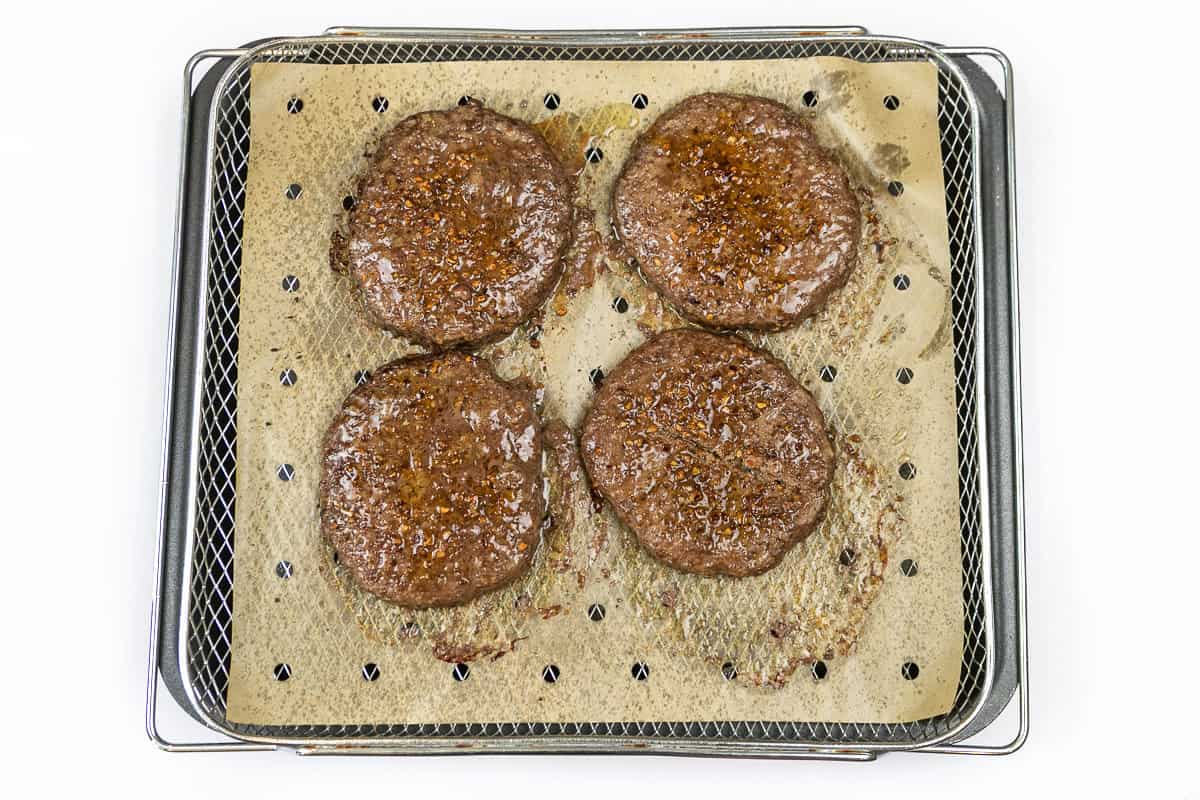 Cook the hamburger patties for twenty to twenty-three minutes at three hundred and seventy-five degrees Fahrenheit. Internal temperature should reach one hundred and sixty degrees Fahrenheit.