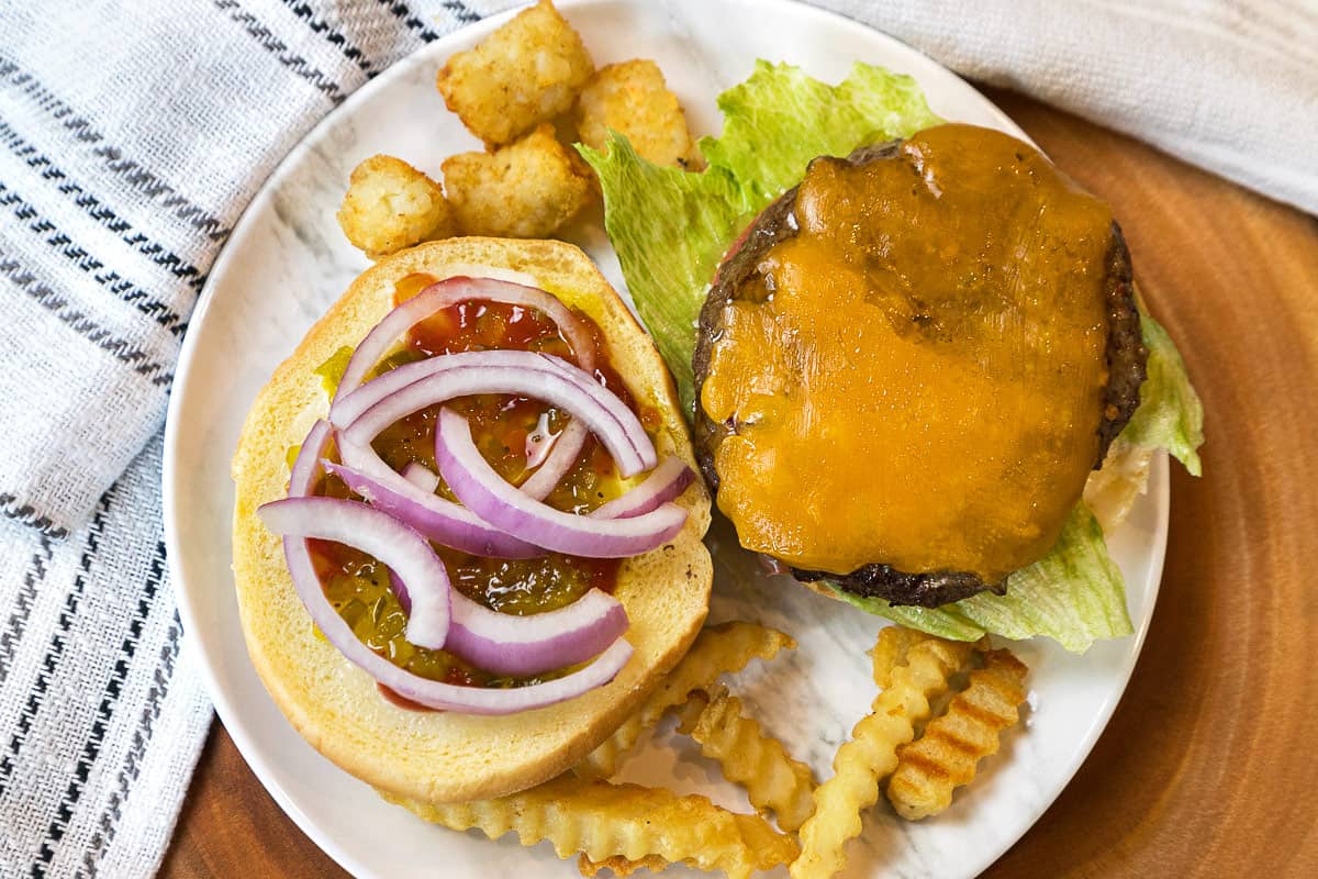 A hamburger on a bun with all the trimmings.
