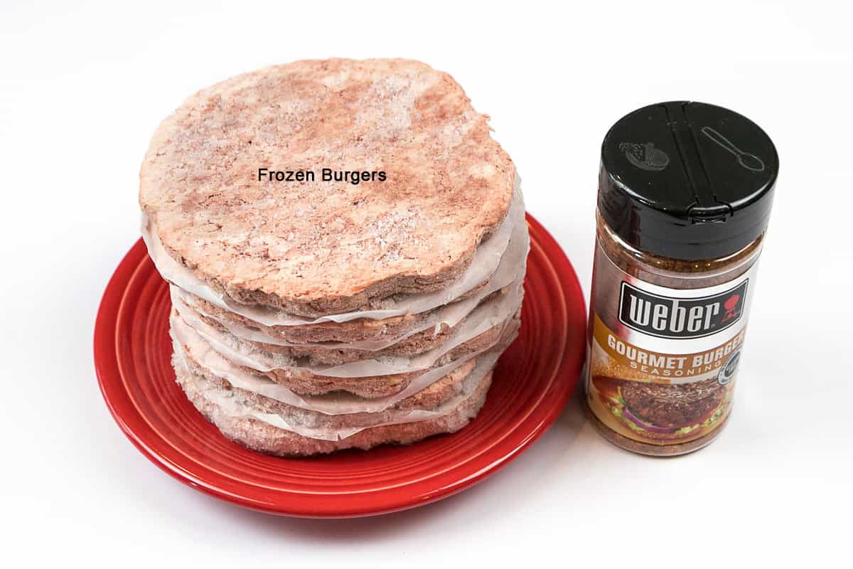 Ingredients for frozen burgers in the air fryer. Four ground beef patties. Weber gourmet burger seasoning.