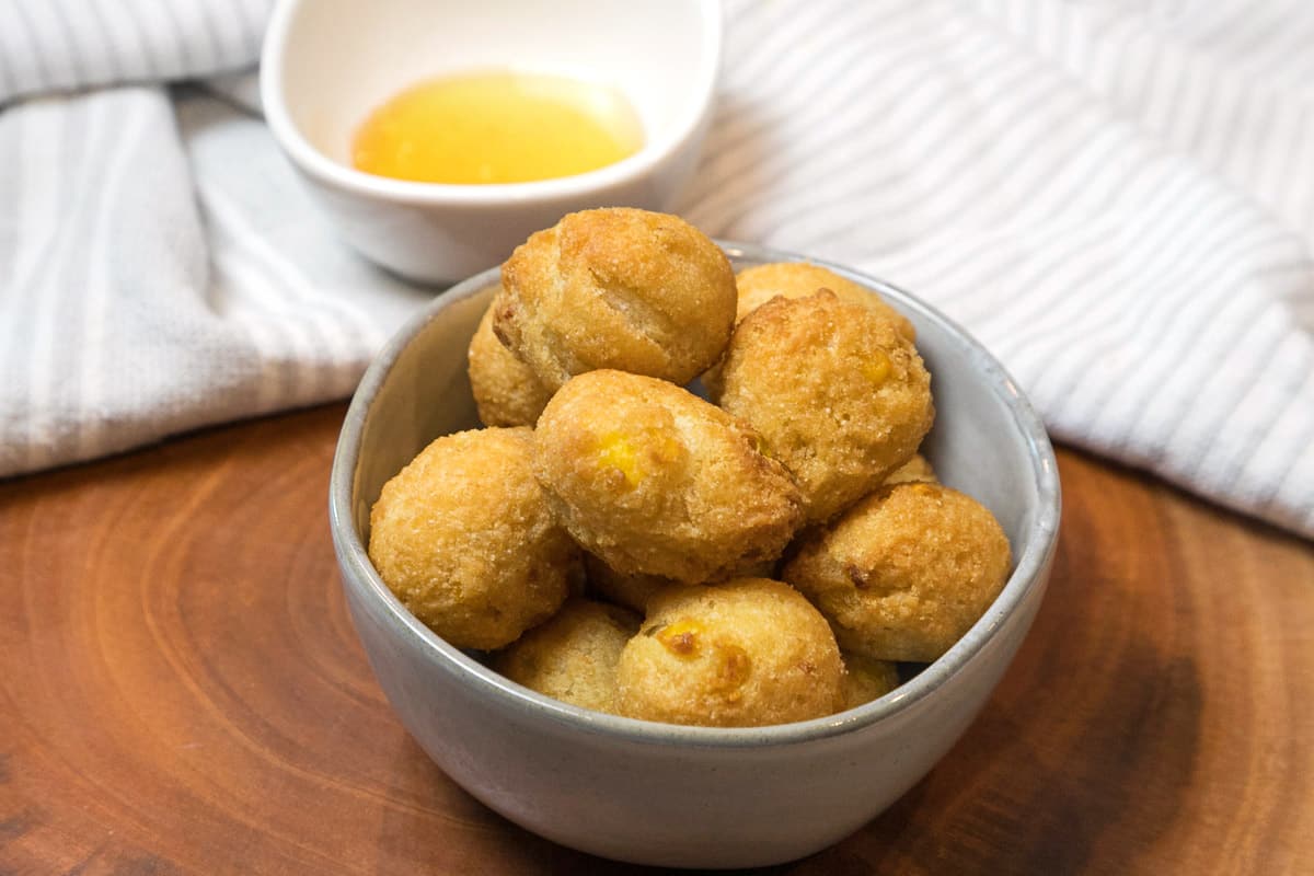 Crispy hush puppies in a bowl.