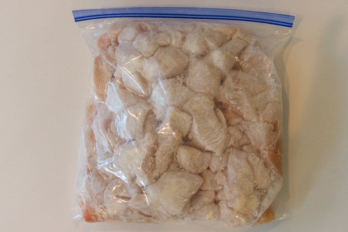 Flour added to the chicken in the bag.
