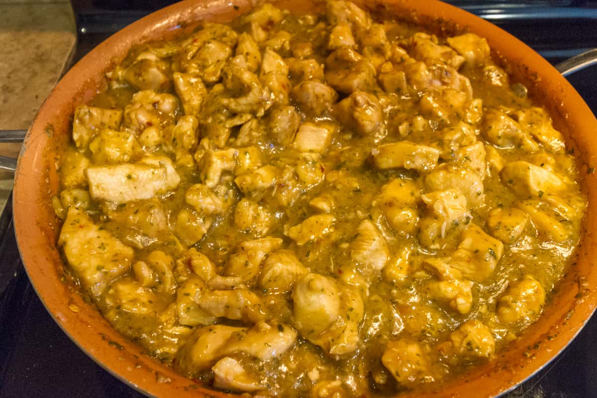 Simmer chicken in the seasoning sauce for ten minutes.