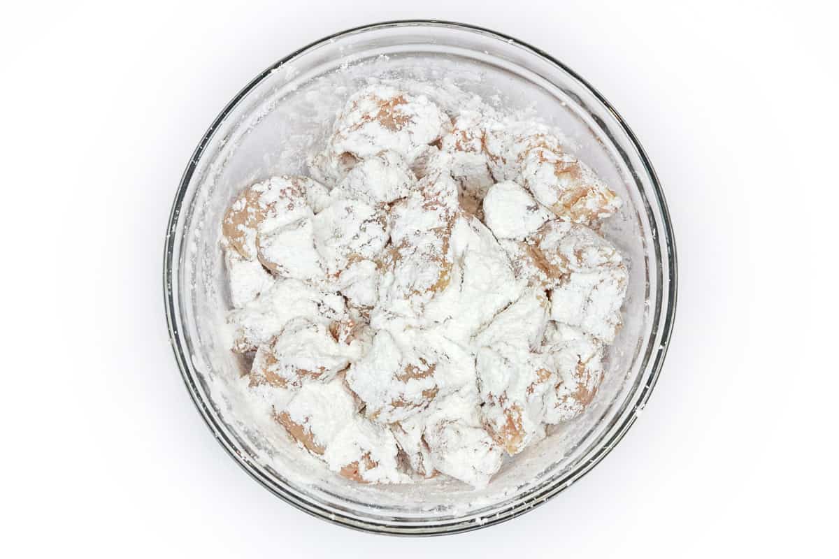 Coat the chicken pieces with corn starch.