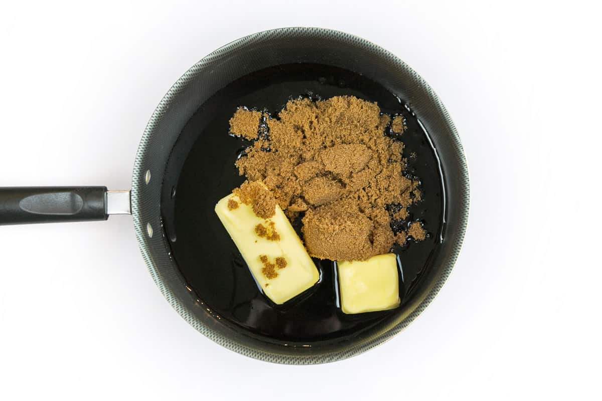 Unsalted butter, dark brown sugar, molasses, and maple syrup in a saucepan.
