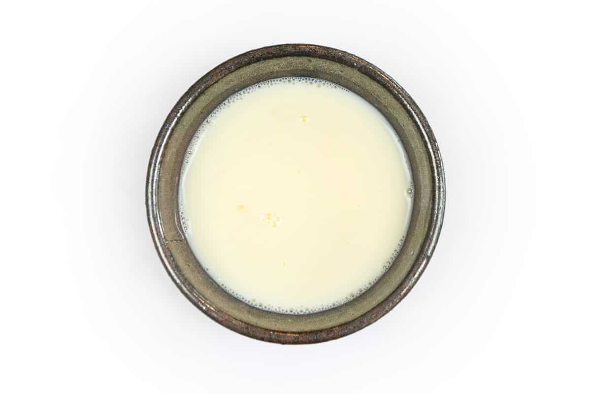 One beaten egg and milk in a bowl.