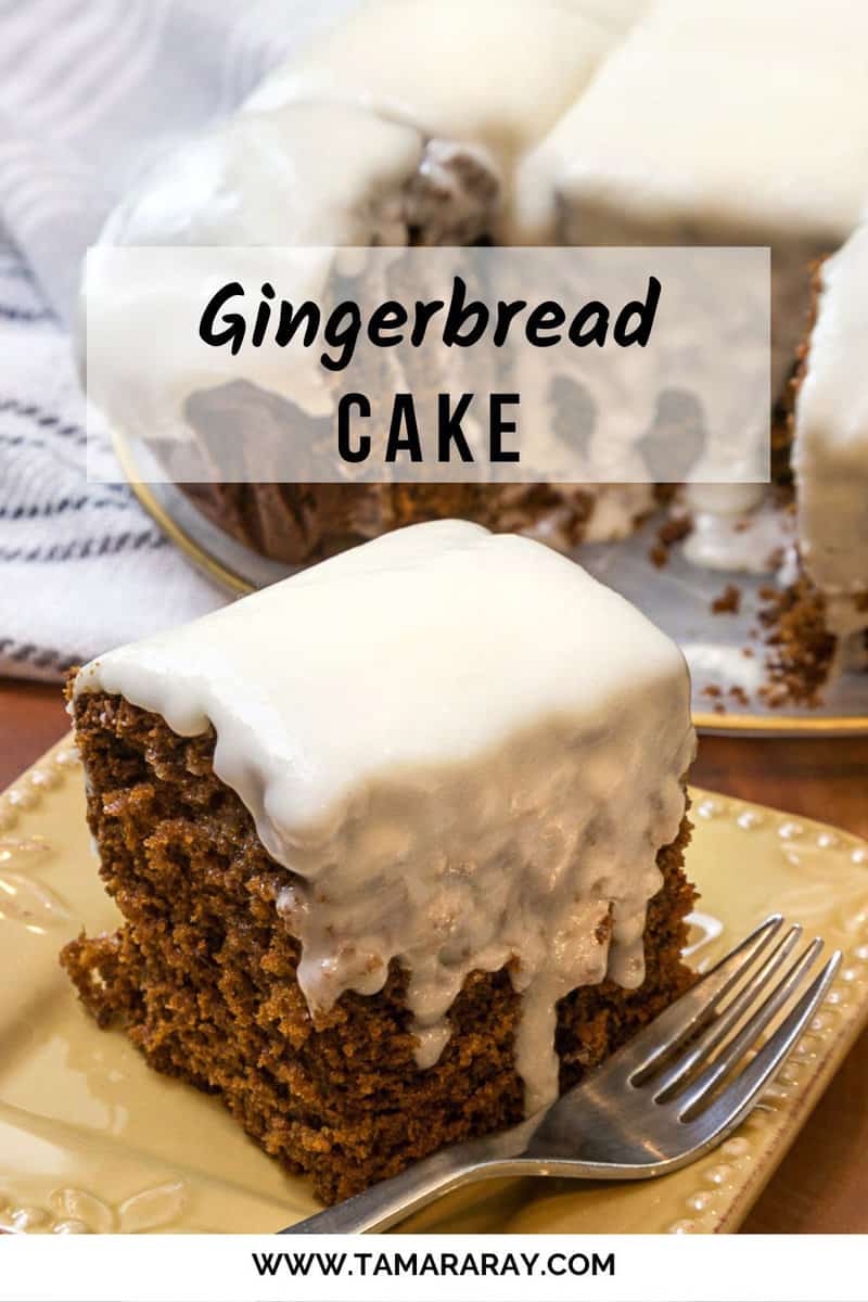 Gingerbread cake with cream cheese frosting on a plate.