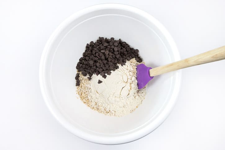 Chocolate chips, rolled oats, and flour in a large bowl.