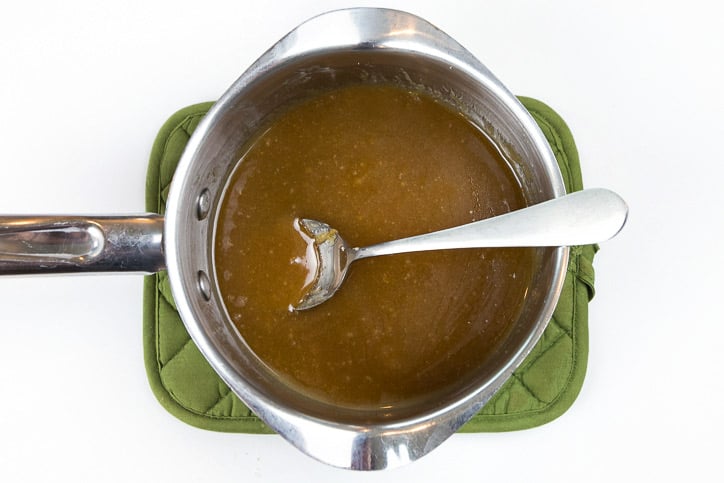 Corn syrup, butter, and brown sugar in a pot on the stove.