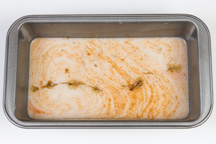 Cayenne pepper, bold creole seasoning, Worcestershire sauce, milk, and cream of mushroom soup in a loaf pan.