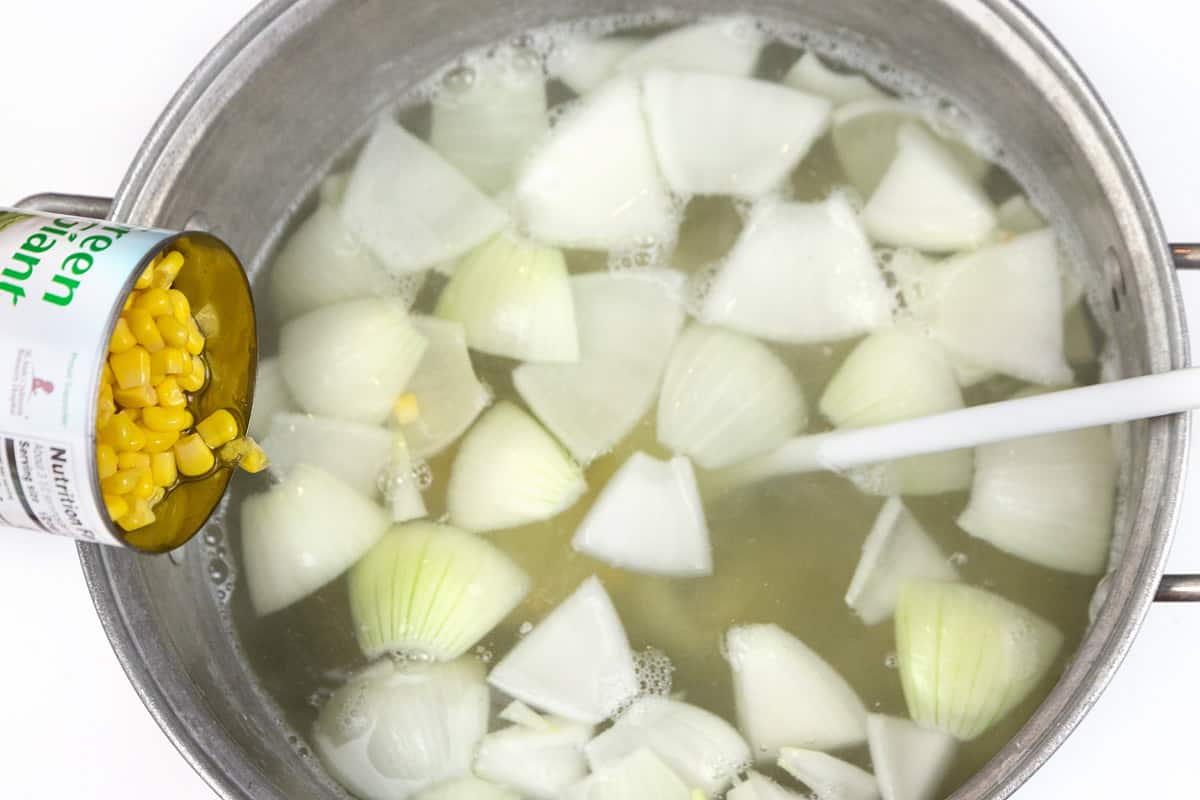 Drain the liquid out of the cans of corn and add them to the pot of soup.