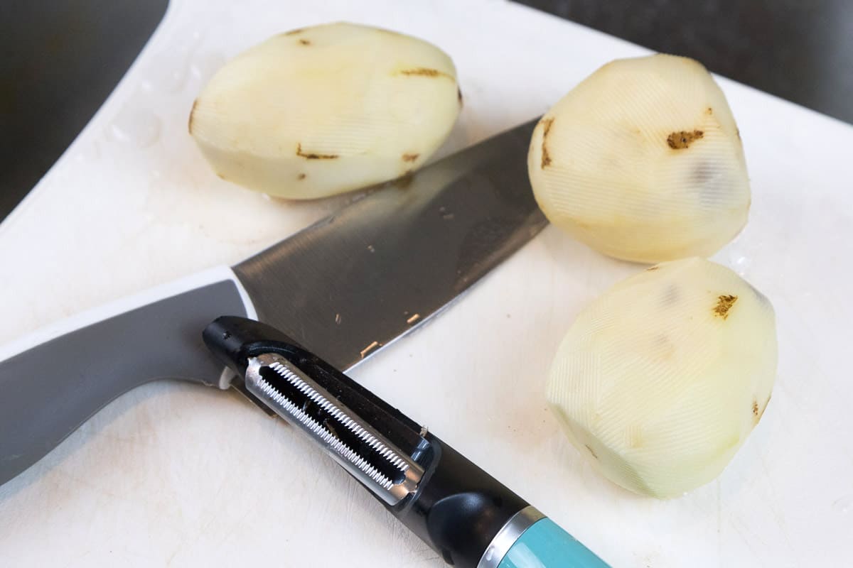 Peel the potatoes.