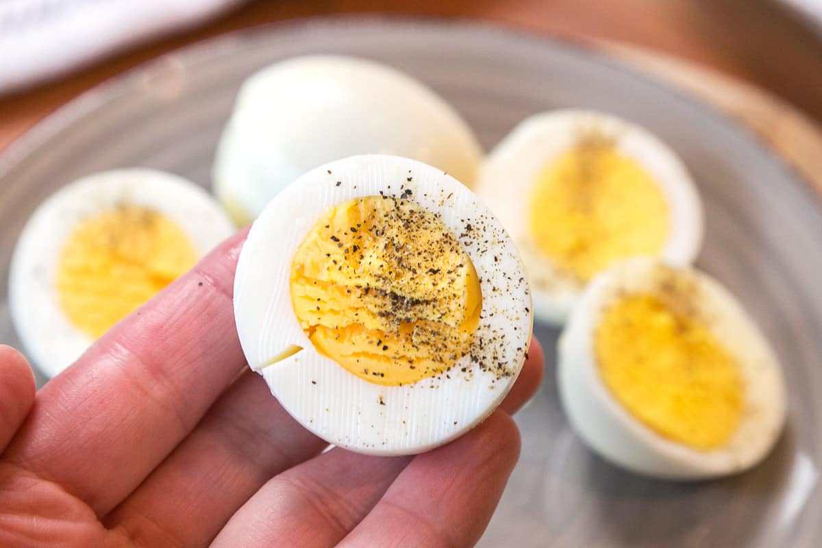 Hard-boiled eggs sliced in half sprinkled with salt and pepper.