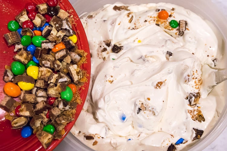 Cut up Halloween candy is added to the semi frozen ice cream.