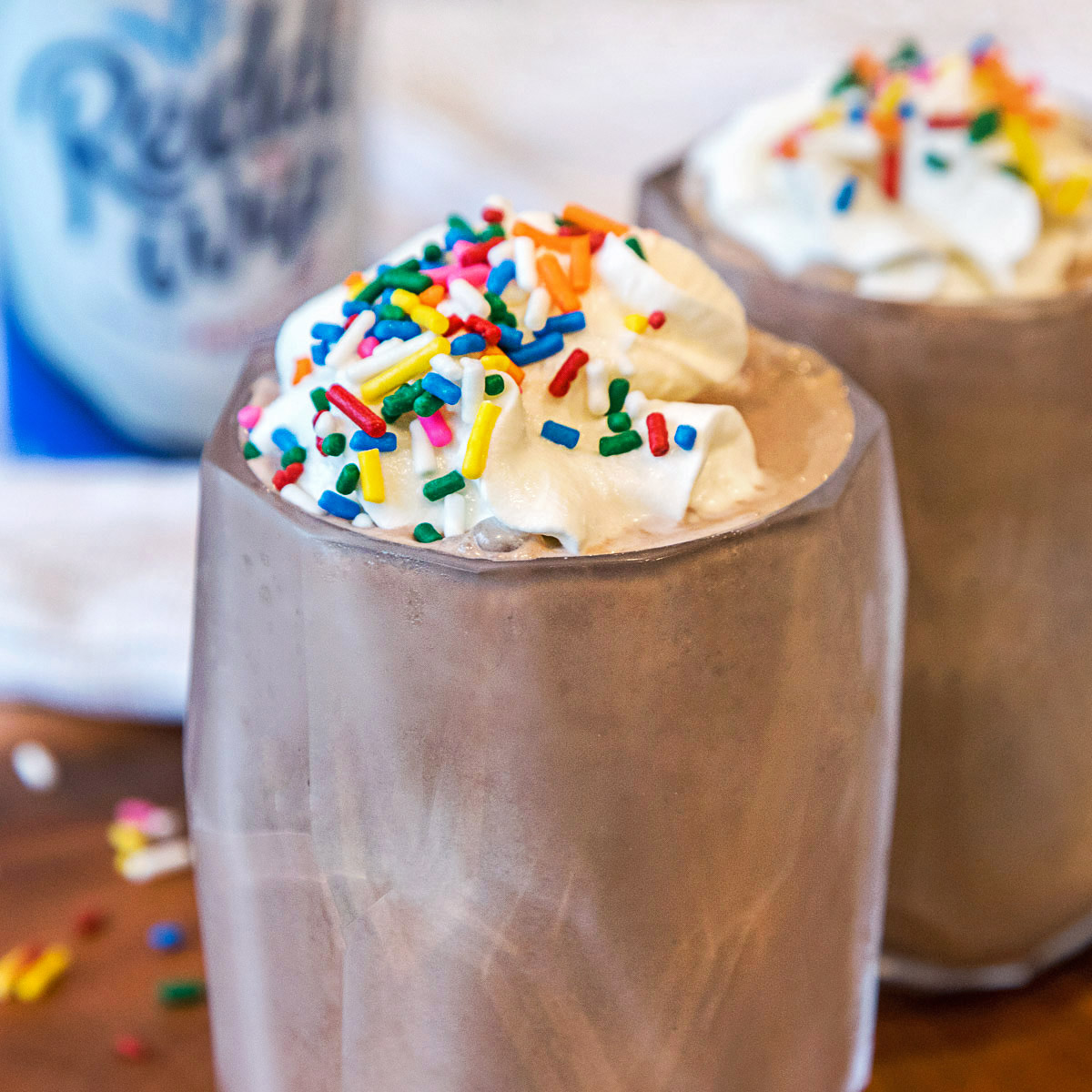 Homemade chocolate milkshake with sprinkes in a cup.